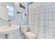 Bathroom features a pedestal sink, toilet, and shower with patterned curtain at 8676 Currituck Sound Ln, Orlando, FL 32829