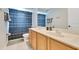 Bathroom featuring double sink vanity with light wood cabinets and a shower/tub combination at 8676 Currituck Sound Ln, Orlando, FL 32829