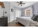 Cozy bedroom with hardwood floors, ceiling fan, double closets, and a window at 8676 Currituck Sound Ln, Orlando, FL 32829