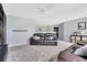 Large bonus room with carpet floors, a couch, and a wall shelf at 8676 Currituck Sound Ln, Orlando, FL 32829
