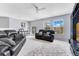 Spacious bonus room with two couches, a ceiling fan, carpet floors, and large windows at 8676 Currituck Sound Ln, Orlando, FL 32829