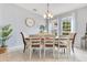 Cozy dining room with a rustic table set, bright windows, and elegant chandelier at 8676 Currituck Sound Ln, Orlando, FL 32829