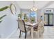 Bright dining room with a wooden table, neutral walls, and a chandelier at 8676 Currituck Sound Ln, Orlando, FL 32829