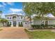 Beautiful two-story home showcases manicured landscaping, a spacious driveway, and a charming facade at 8676 Currituck Sound Ln, Orlando, FL 32829