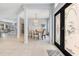 Inviting foyer with tile flooring, decorative glass front doors, and a view into the formal dining area at 8676 Currituck Sound Ln, Orlando, FL 32829