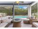 Inviting lanai with wicker furniture overlooking sparkling in-ground pool with a screened enclosure at 8676 Currituck Sound Ln, Orlando, FL 32829