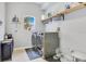 Bright laundry room with washer, dryer, shelving, and a window at 8676 Currituck Sound Ln, Orlando, FL 32829