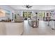 Spacious living room with neutral decor, tile floors, comfortable seating, and backyard access at 8676 Currituck Sound Ln, Orlando, FL 32829
