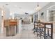Open concept living room with bar-style seating, tiled floors and stainless steel trash can at 8676 Currituck Sound Ln, Orlando, FL 32829