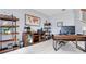Bright office space with tile floors, a world map wall art, and built-in shelving units at 8676 Currituck Sound Ln, Orlando, FL 32829