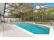 Sparkling in-ground pool featuring a screened enclosure with a patio at 8676 Currituck Sound Ln, Orlando, FL 32829