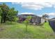 Large backyard with a screened-in patio and lush landscaping, perfect for enjoying the outdoors in privacy at 9843 Nokay Dr, Orlando, FL 32836