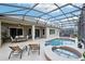 Spacious backyard featuring a pool, spa, lounge chairs, and a screened-in patio, ideal for outdoor entertaining and relaxation at 9843 Nokay Dr, Orlando, FL 32836