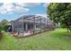 Expansive backyard with a screened lanai, patio, and lush landscaping, offering a private outdoor oasis at 9843 Nokay Dr, Orlando, FL 32836