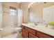Cozy bathroom with a tub and shower combination, complemented by a classic vanity and ample lighting at 9843 Nokay Dr, Orlando, FL 32836