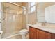 Modern bathroom featuring a glass-enclosed shower, vanity with dark wood cabinets, and tiled walls at 9843 Nokay Dr, Orlando, FL 32836