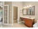 Bright bathroom with a double vanity, a water closet, and access to a lanai at 9843 Nokay Dr, Orlando, FL 32836