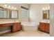 Bright bathroom with a garden tub, double vanity, and a glass block window at 9843 Nokay Dr, Orlando, FL 32836