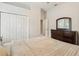 Bedroom with a dresser, double door closets, and an ensuite at 9843 Nokay Dr, Orlando, FL 32836