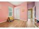 Bright bedroom with wood-look flooring, a large window, and ample closet space, creating a cozy retreat at 9843 Nokay Dr, Orlando, FL 32836