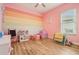 Playful bedroom with colorful decor, wood-look floors, and a cozy layout perfect for a space at 9843 Nokay Dr, Orlando, FL 32836