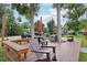 Enjoy outdoor gatherings on the deck with seating, tables, and a grill, surrounded by trees and a golf cart at 9843 Nokay Dr, Orlando, FL 32836