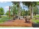 Expansive outdoor deck area with lounge chairs, picnic tables, and barbecue grills for community gatherings at 9843 Nokay Dr, Orlando, FL 32836