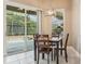 Bright dining area adjacent to pool with wooden table, natural light and sliding glass doors at 9843 Nokay Dr, Orlando, FL 32836