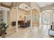 Open dining room featuring elegant columns, a modern chandelier, and natural light at 9843 Nokay Dr, Orlando, FL 32836
