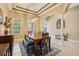 Bright dining room featuring a wooden table, decorative rug, modern light fixture, and open access to other living areas at 9843 Nokay Dr, Orlando, FL 32836