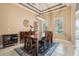 Charming dining room with modern light fixture, decorative rug, and ample natural light from the window at 9843 Nokay Dr, Orlando, FL 32836