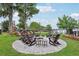 Cozy community fire pit with Adirondack chairs provides a relaxing outdoor gathering space by the lake at 9843 Nokay Dr, Orlando, FL 32836