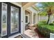 Close-up of an elegant front door with decorative glass and brick walkway at 9843 Nokay Dr, Orlando, FL 32836