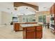 Spacious kitchen features an island, stainless steel appliances, and is open to the living room with natural light at 9843 Nokay Dr, Orlando, FL 32836