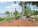 Scenic lake view from the wooden deck with lounge chairs offers a relaxing outdoor experience at 9843 Nokay Dr, Orlando, FL 32836