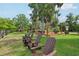 Relaxing lakefront seating with Adirondack chairs and gathering spaces offer a serene outdoor experience at 9843 Nokay Dr, Orlando, FL 32836