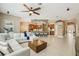 Open living room flows into the kitchen, featuring tile floors and neutral decor at 9843 Nokay Dr, Orlando, FL 32836