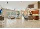 Spacious open-concept living room and kitchen with tile floors and a breakfast bar at 9843 Nokay Dr, Orlando, FL 32836