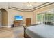 The spacious main bedroom has tray ceilings, an outdoor view through sliding glass doors and tile flooring at 9843 Nokay Dr, Orlando, FL 32836