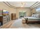 Spacious main bedroom features a tray ceiling, tile flooring, and access to the patio through sliding glass doors at 9843 Nokay Dr, Orlando, FL 32836