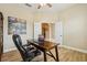 Home office with wood-look tile flooring, neutral walls, open french doors and views of the entry hall at 9843 Nokay Dr, Orlando, FL 32836