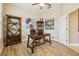 This home office is filled with natural light, beautiful decorations and wood-look tile flooring at 9843 Nokay Dr, Orlando, FL 32836