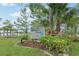 A welcoming sign for Robson Park is surrounded by lush greenery and a glimpse of the tranquil lake at 9843 Nokay Dr, Orlando, FL 32836