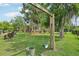 Charming community playground and lounge area amidst lush greenery offers fun for the whole Gathering at 9843 Nokay Dr, Orlando, FL 32836