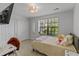 Serene bedroom with a cozy bed, soft lighting, and a view of the outdoors at 10124 Pink Carnation Ct, Orlando, FL 32825