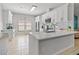 Spacious kitchen with white cabinetry, island, stainless steel appliances, and plenty of natural light at 10124 Pink Carnation Ct, Orlando, FL 32825