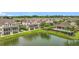 An aerial view of a neighborhood with a pond and community pool, surrounded by lush landscapes at 1027 Cedar Bay Ln, Winter Springs, FL 32708