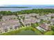 An aerial shot showcases a neighborhood with a pond and community pool, all beautifully landscaped at 1027 Cedar Bay Ln, Winter Springs, FL 32708