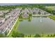 Aerial view of a townhome community surrounding a scenic lake with a fountain, highlighting the peaceful residential setting at 1027 Cedar Bay Ln, Winter Springs, FL 32708