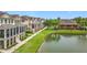 An aerial view shows a community pool and pond surrounded by lush lawns and townhomes at 1027 Cedar Bay Ln, Winter Springs, FL 32708